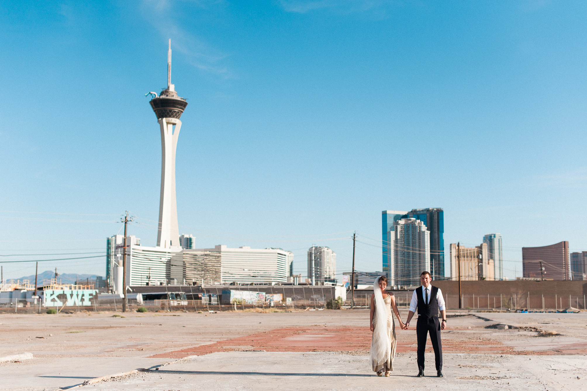 British newlyweds pose in front of the Las Vegas Strip. Captured by Las Vegas Elopement Photographer Briana Morrison