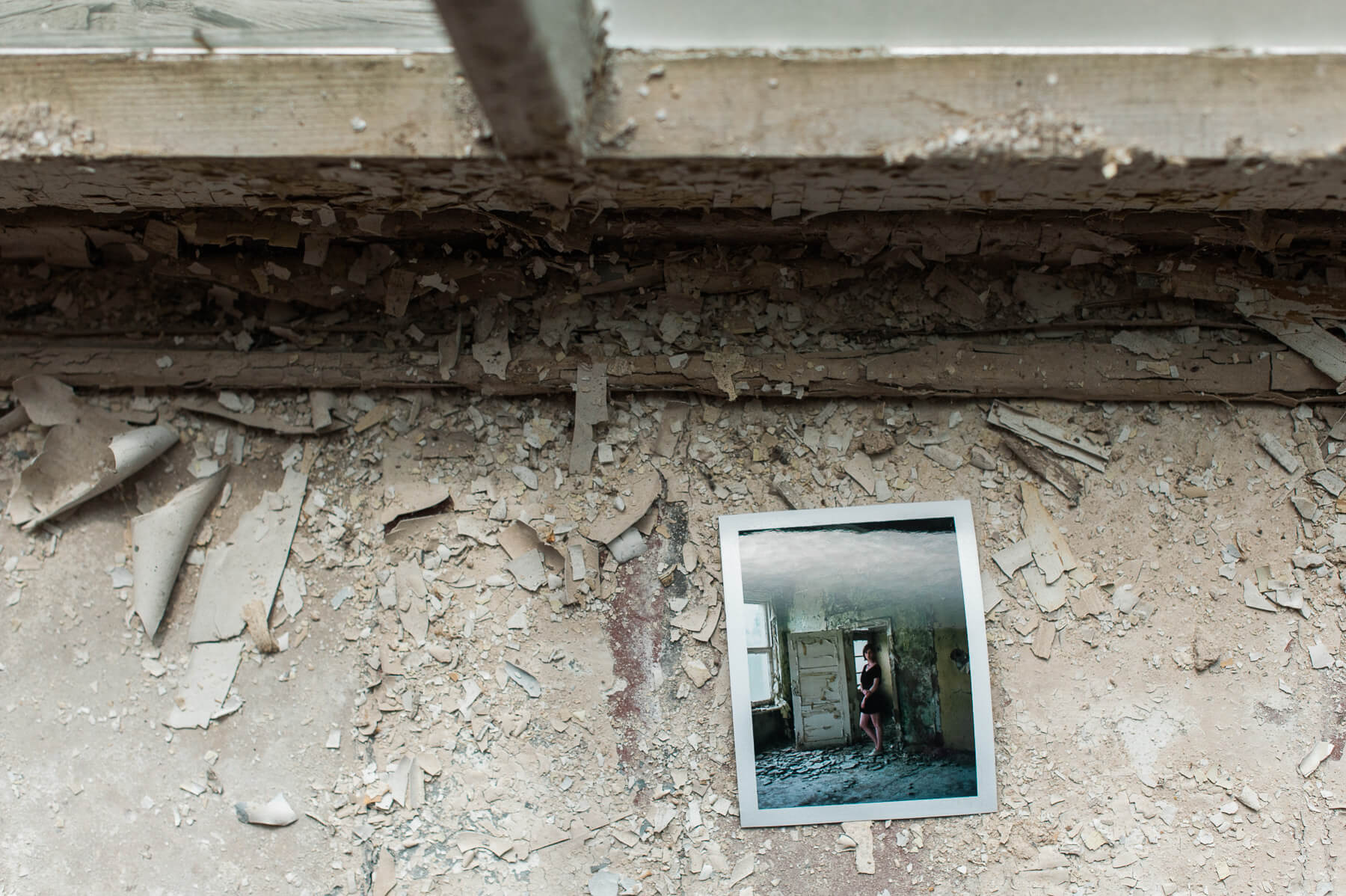 Polaroid of a portrait of a woman inside the decaying interior of Heilstätten Hohenlychen Sanatorium in Lychen, Germany. Photographs by Berlin Portrait Photographer Briana Morrison