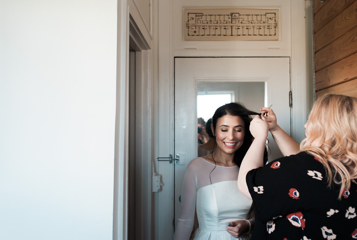 The bride gets her hair touched up. by Ace Hotel wedding photographer Briana Morrison