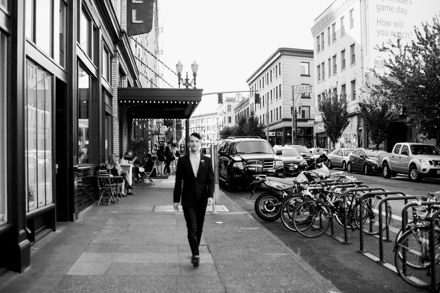 The groom walking down a Portland street. by Ace Hotel wedding photographer Briana Morrison