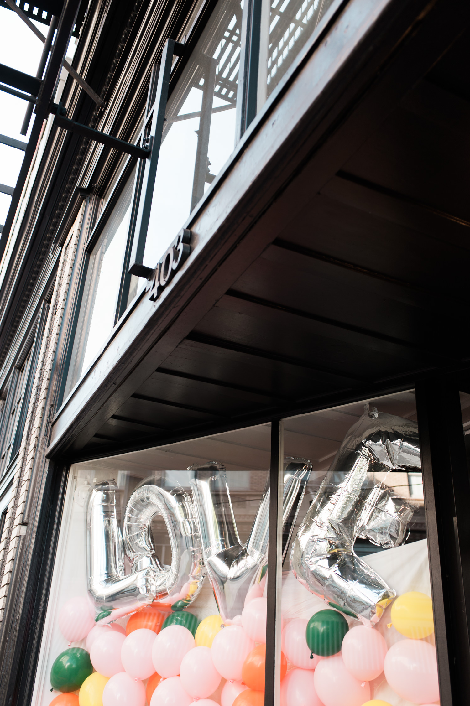 Love sign and balloons at The Cleaners. by Ace Hotel wedding photographer Briana Morrison