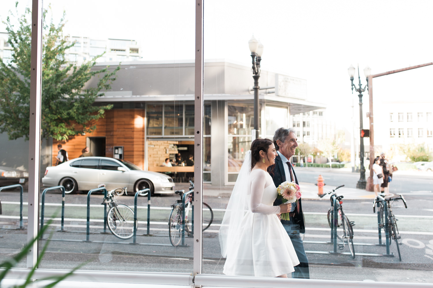 The bride walks with her father towards the aisle. by Ace Hotel wedding photographer Briana Morrison
