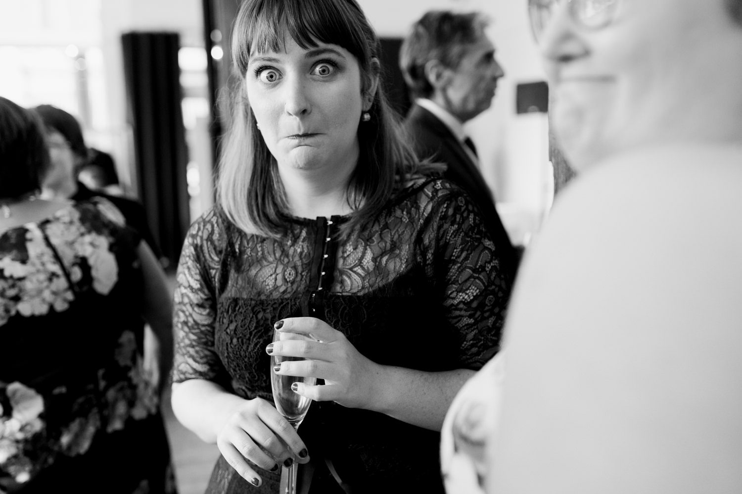 A wedding guest makes a funny face at the camera. by The Cleaners wedding photographer Briana Morrison