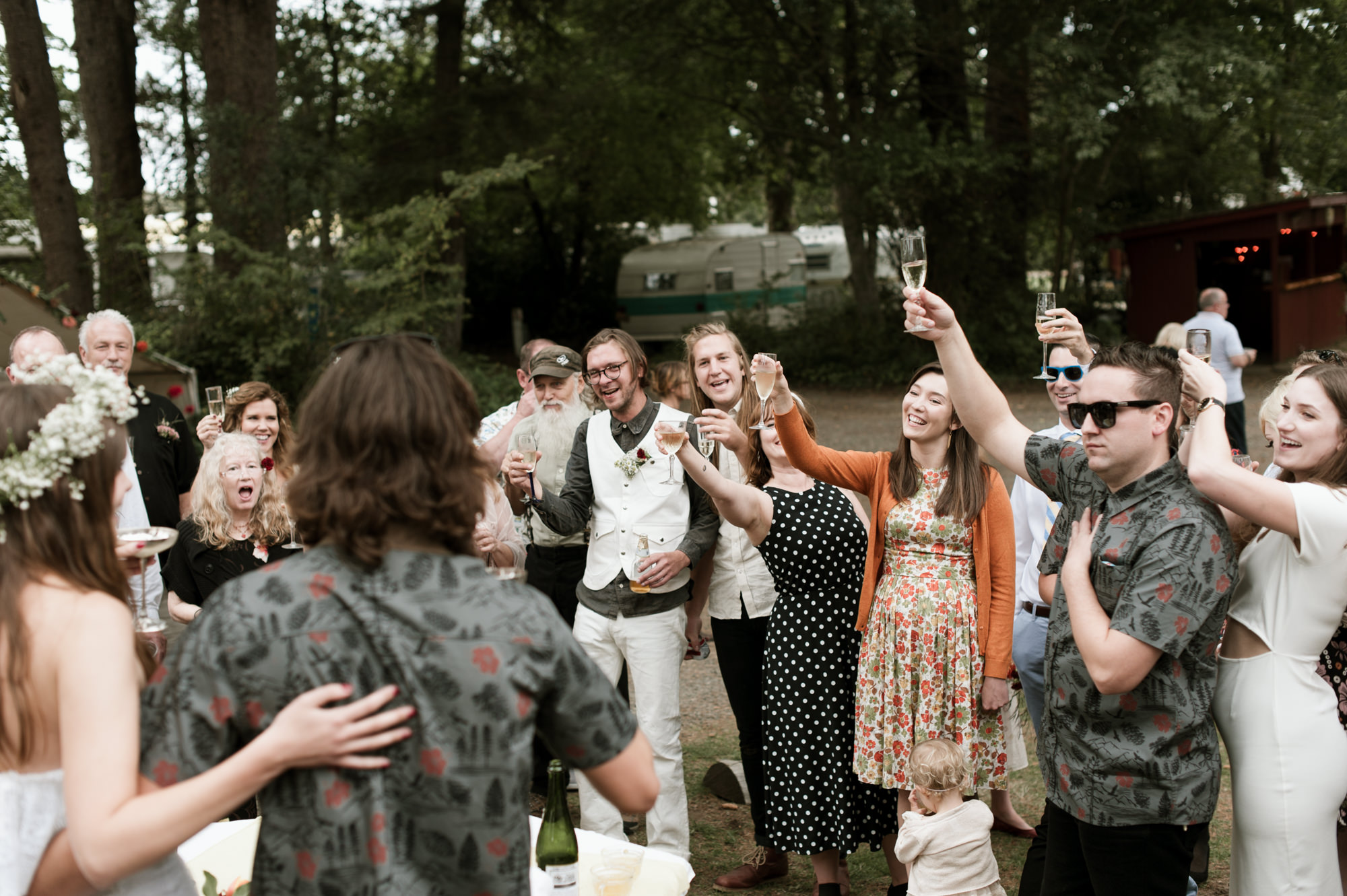 Wedding guest toasting the bride and groom at their vintage Pacific Northwest wedding. West Coast Wedding Photographer Briana Morrison