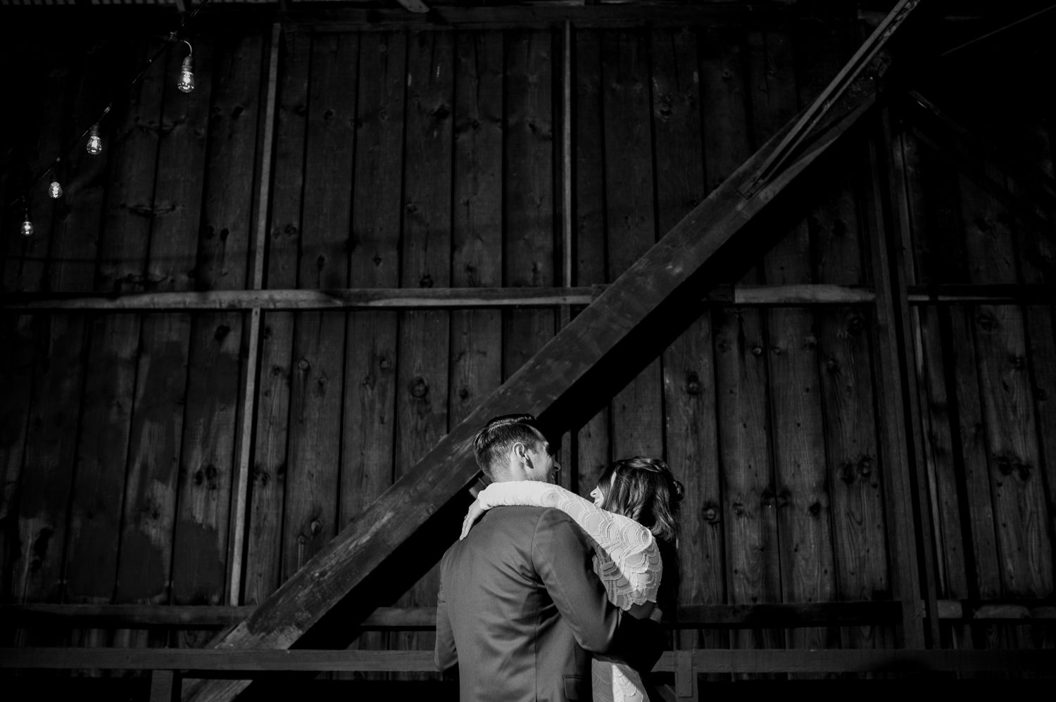 First dance of the bride and groom on a covered bridge. Guests sit down to eat at a wedding on a covered bridge. By West Cost wedding photographer Briana Morrison