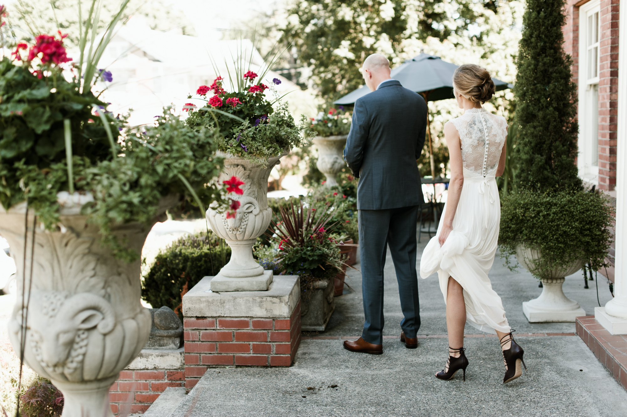 The bride and groom prepare for their first look at the Portland Mayor's Mansion. By Laurelhurst Park wedding photographer Briana Morrison