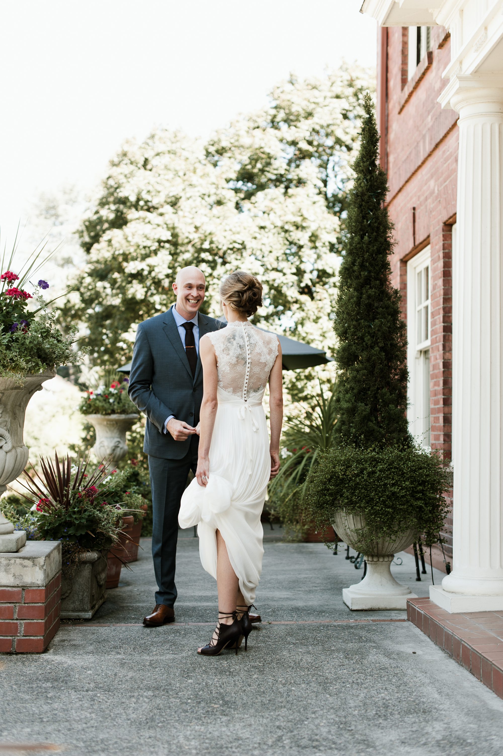 The bride and groom have their first look at the Portland Mayor's Mansion. By Laurelhurst Park wedding photographer Briana Morrison