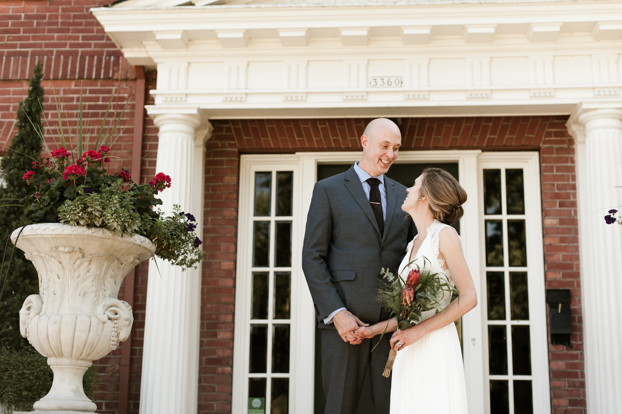 A portrait of the bride and groom in front of the Portland Mayor's Mansion. By Laurelhurst Park wedding photographer Briana Morrison