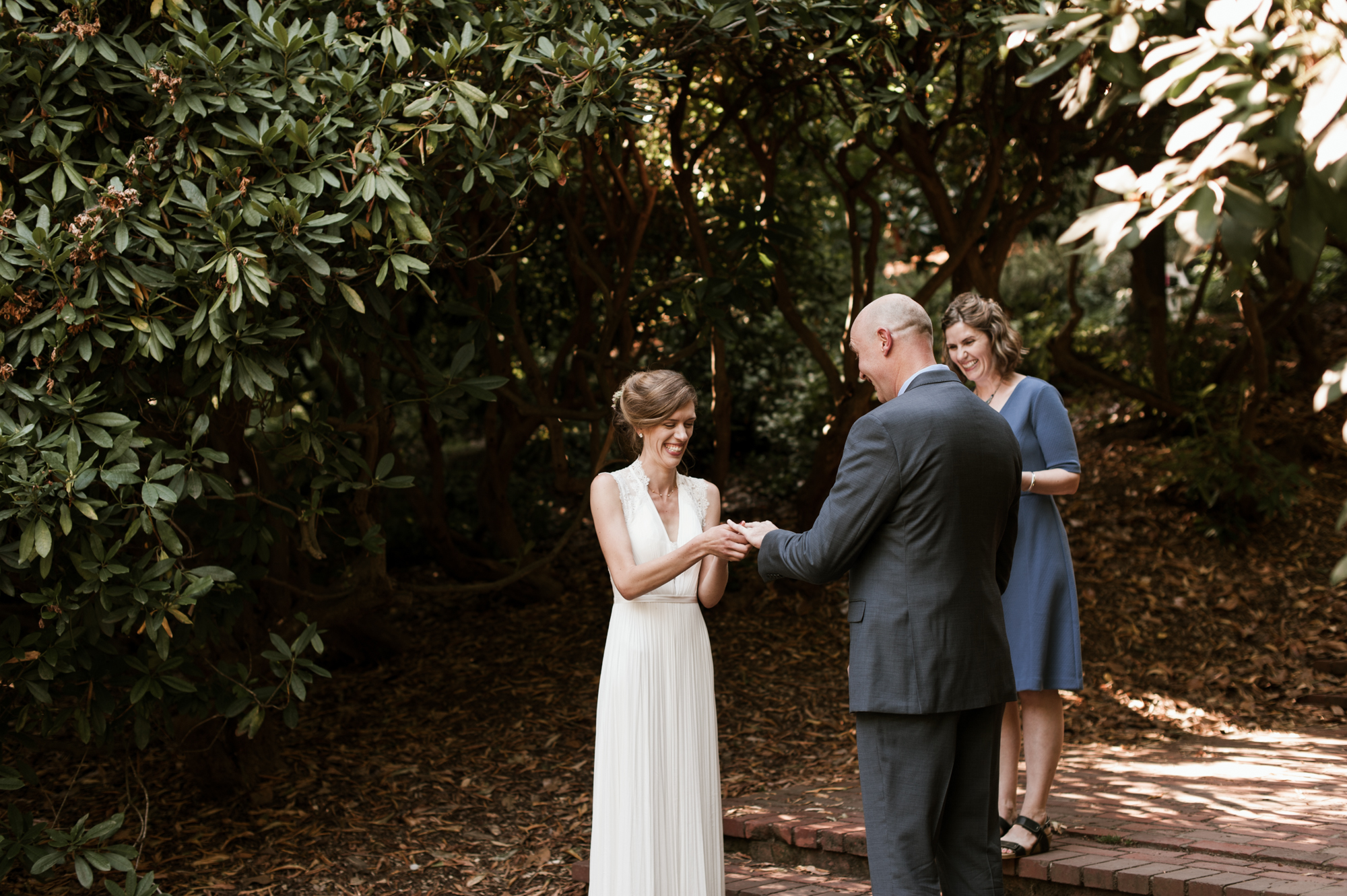The bride puts a ring on it. By Laurelhurst Park wedding photographer Briana Morrison
