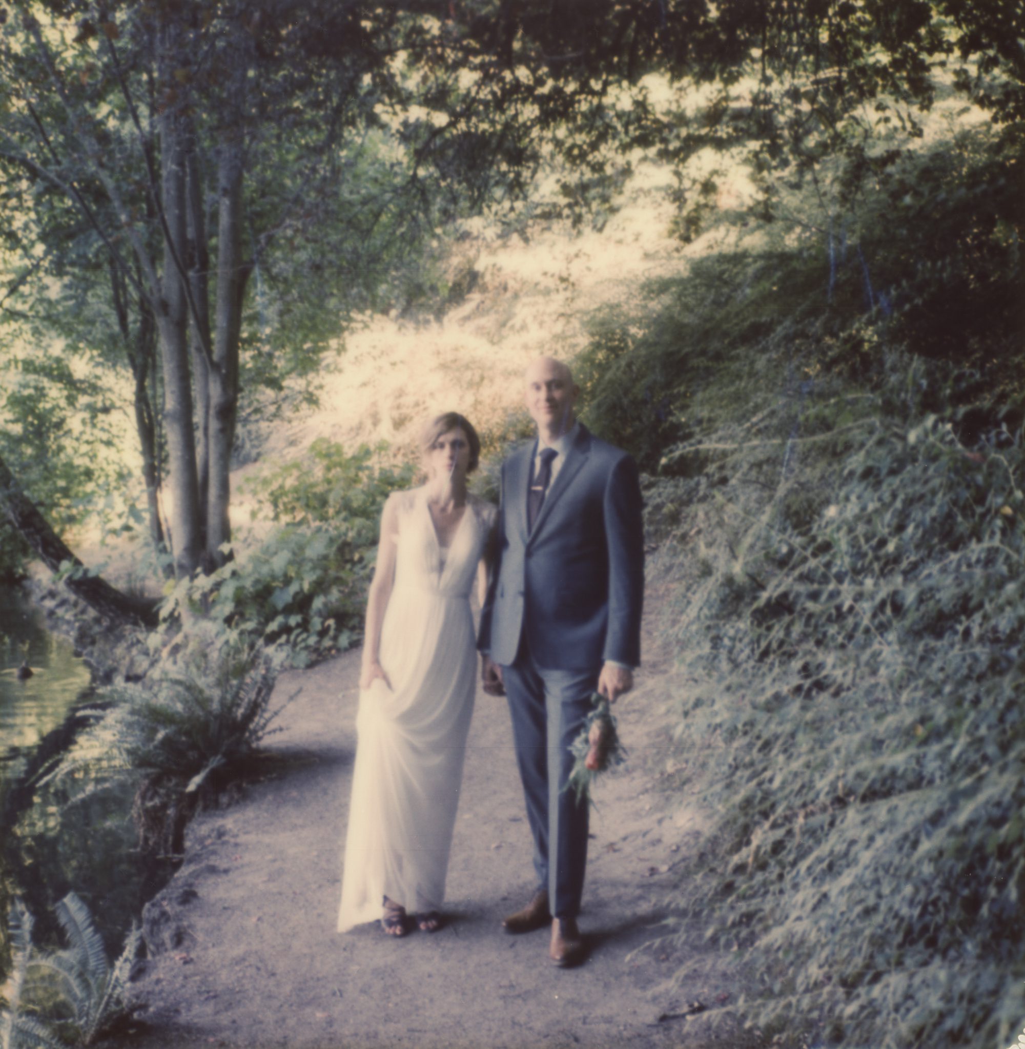Polaroid portrait of the bride and groom in Laurelhurst Park. By wedding photographer Briana Morrison
