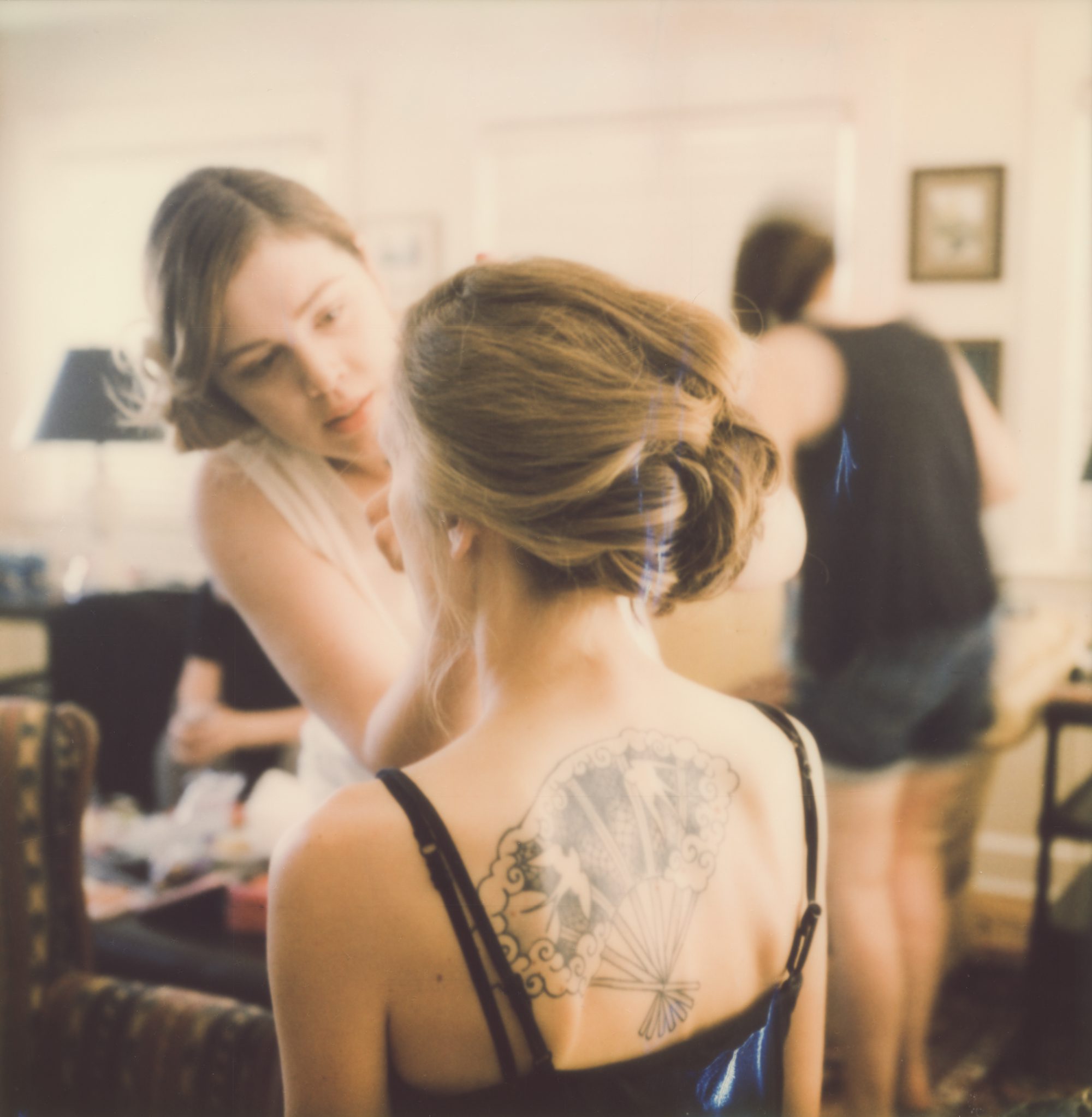 Polaroid portrait of the bride getting her makeup done. By wedding photographer Briana Morrison