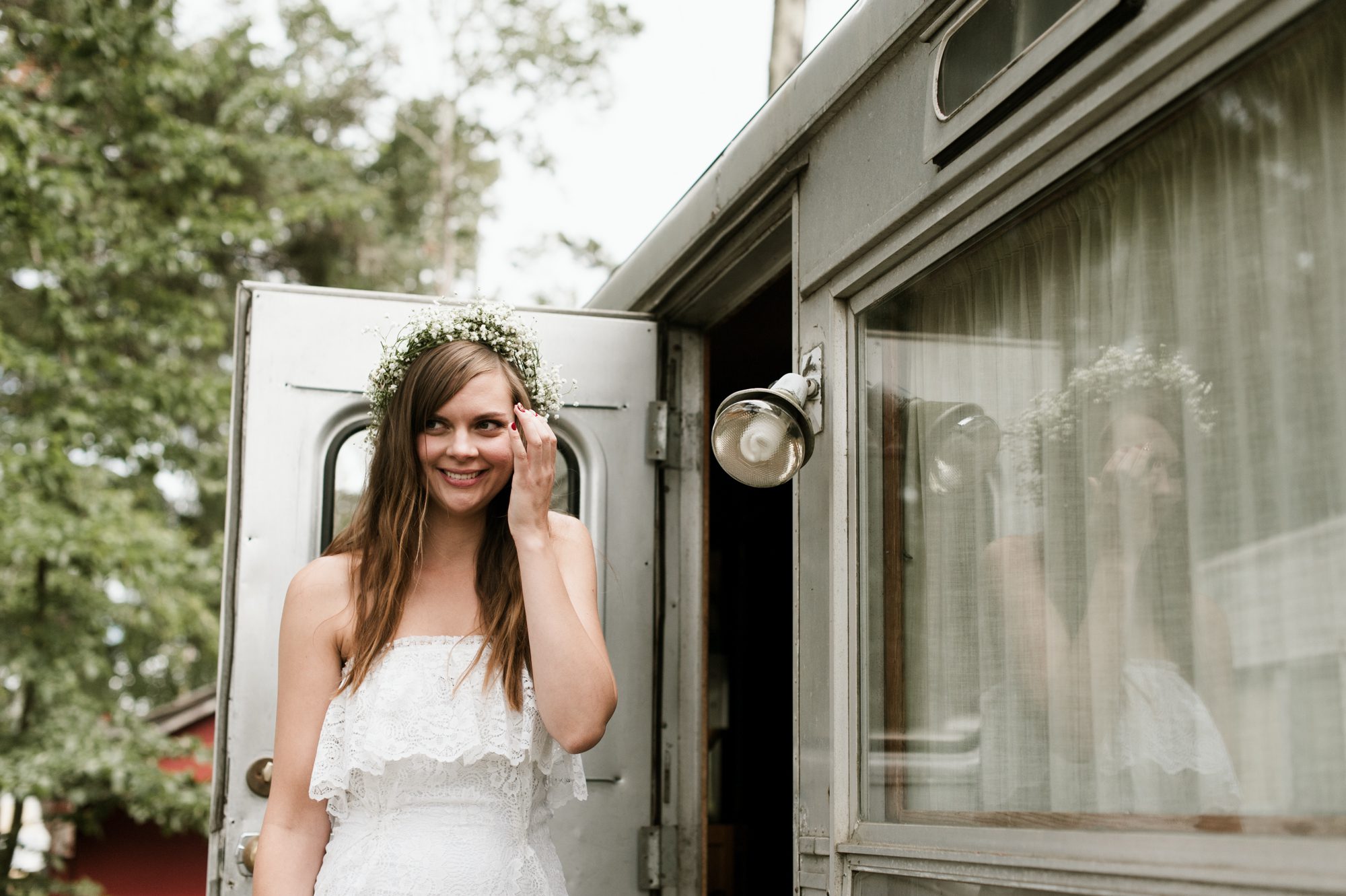 A blushing bride outside a vintage Airstream trailer. By Long Beach, Washington wedding photographer Briana Morrison