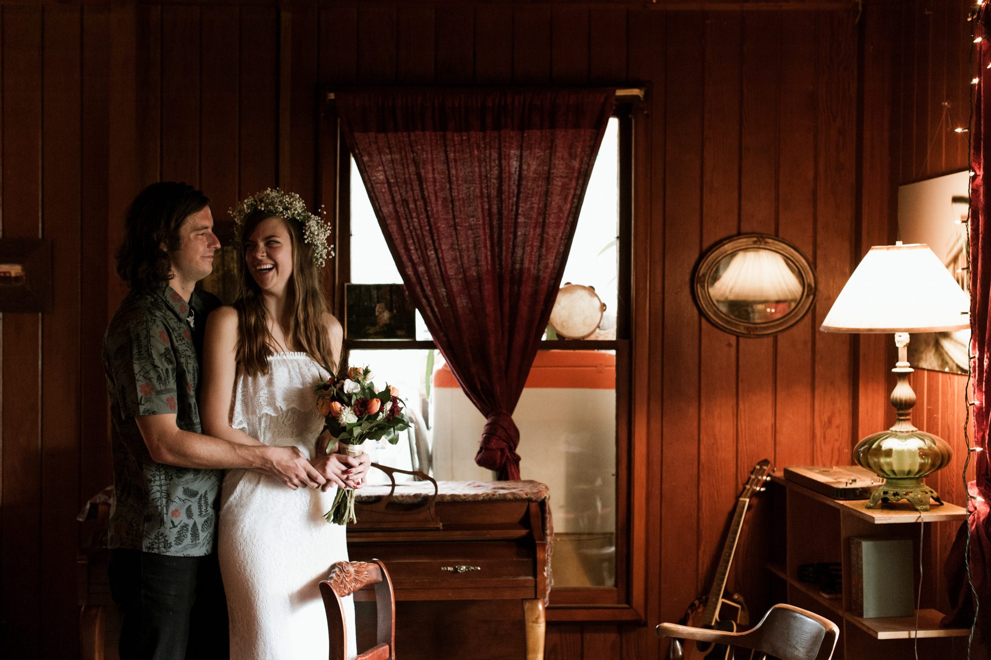 The bride and groom laugh together inside of the Sou'Wester Lodge. By Long Beach, Washington wedding photographer Briana Morrison
