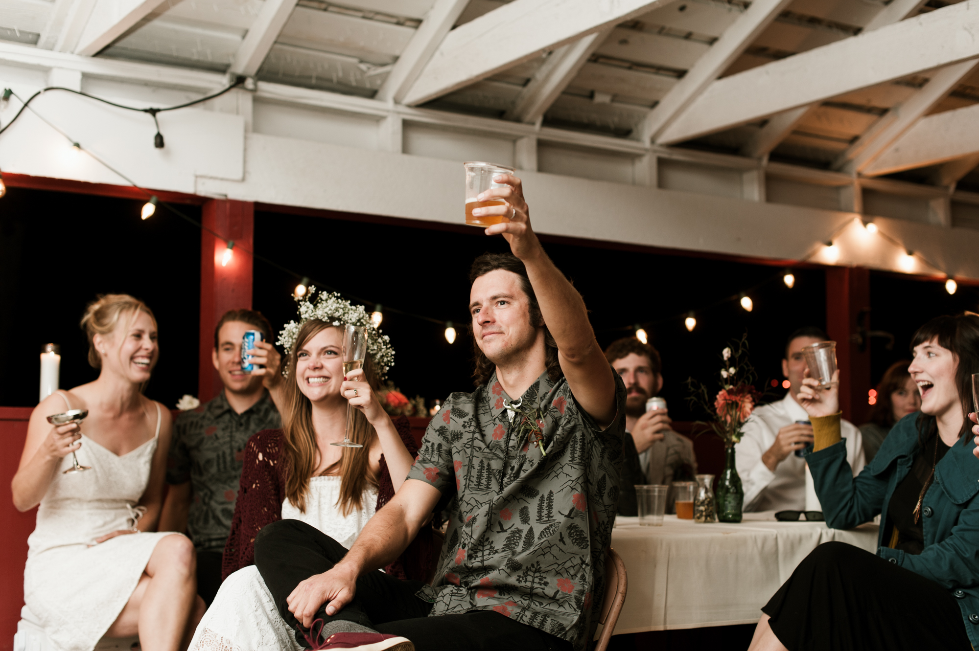 The bride and groom raise their glasses for a toast. By Sou'Wester wedding photographer Briana Morrison
