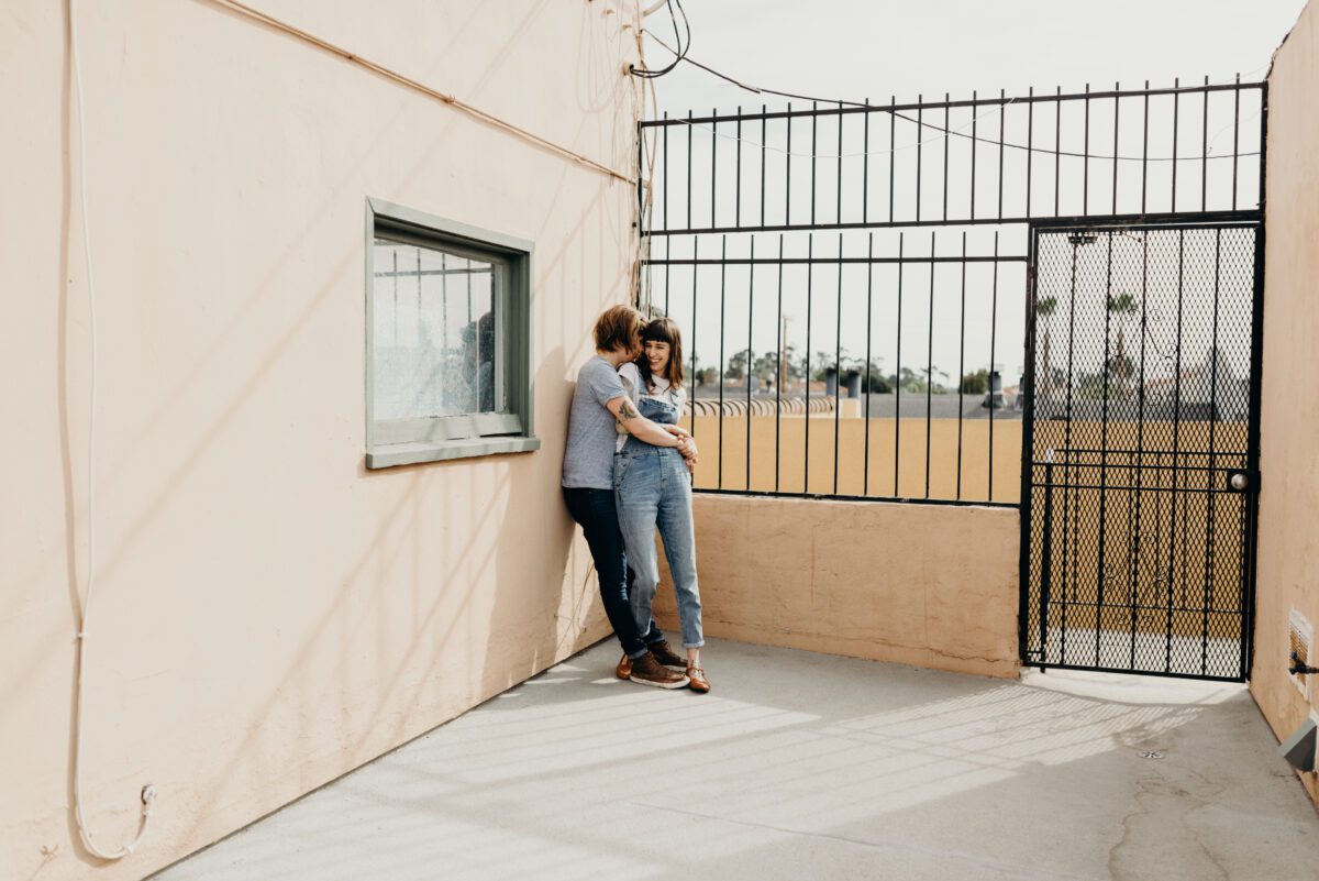 North Park San Diego same sex couple engagement portraits on rooftop terrace.