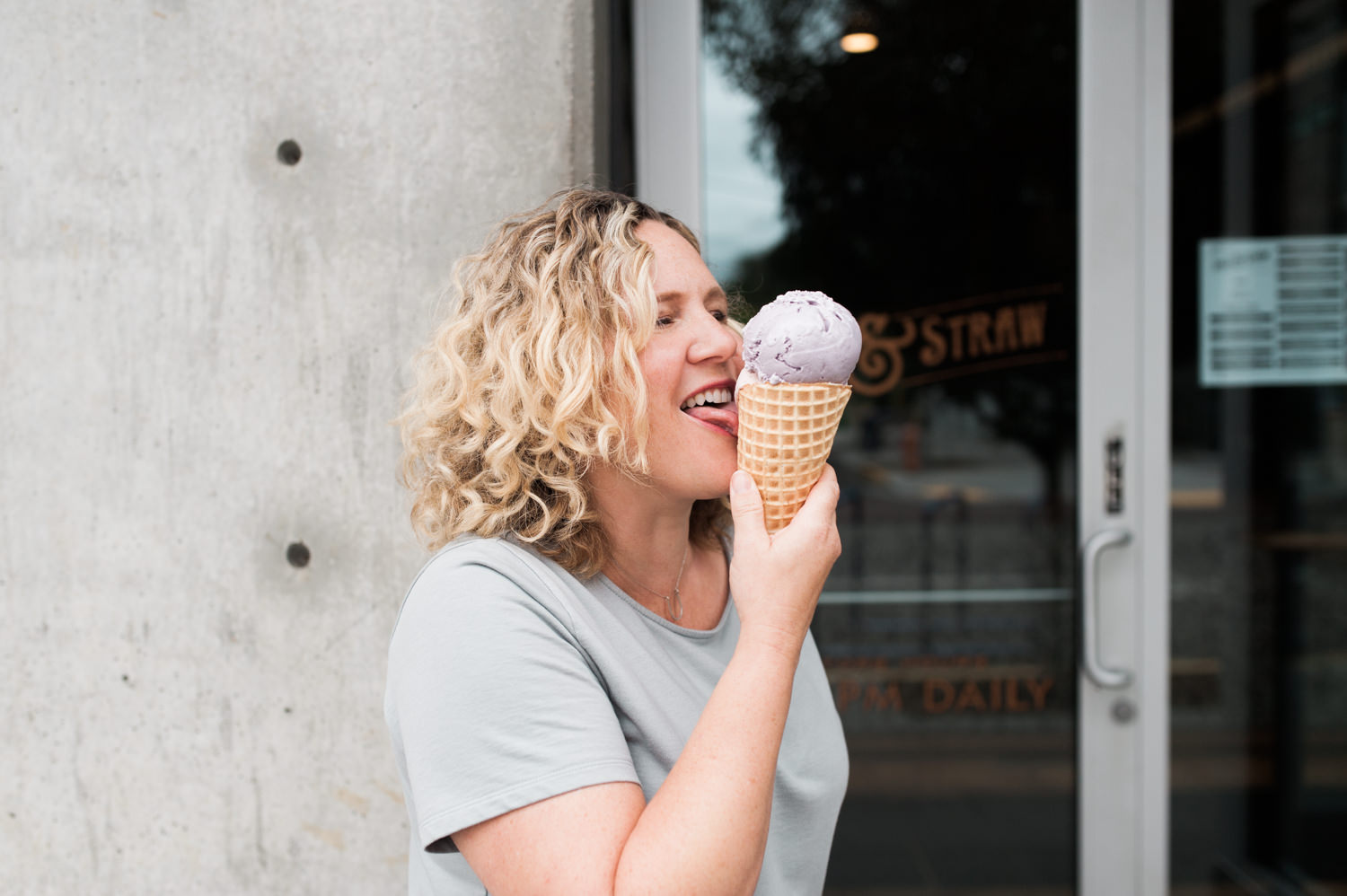 Co-Owner of Salt & Straw, Kim Malek, eating ice cream in Portland, Oregon. By Portland editorial photographer Briana Morrison