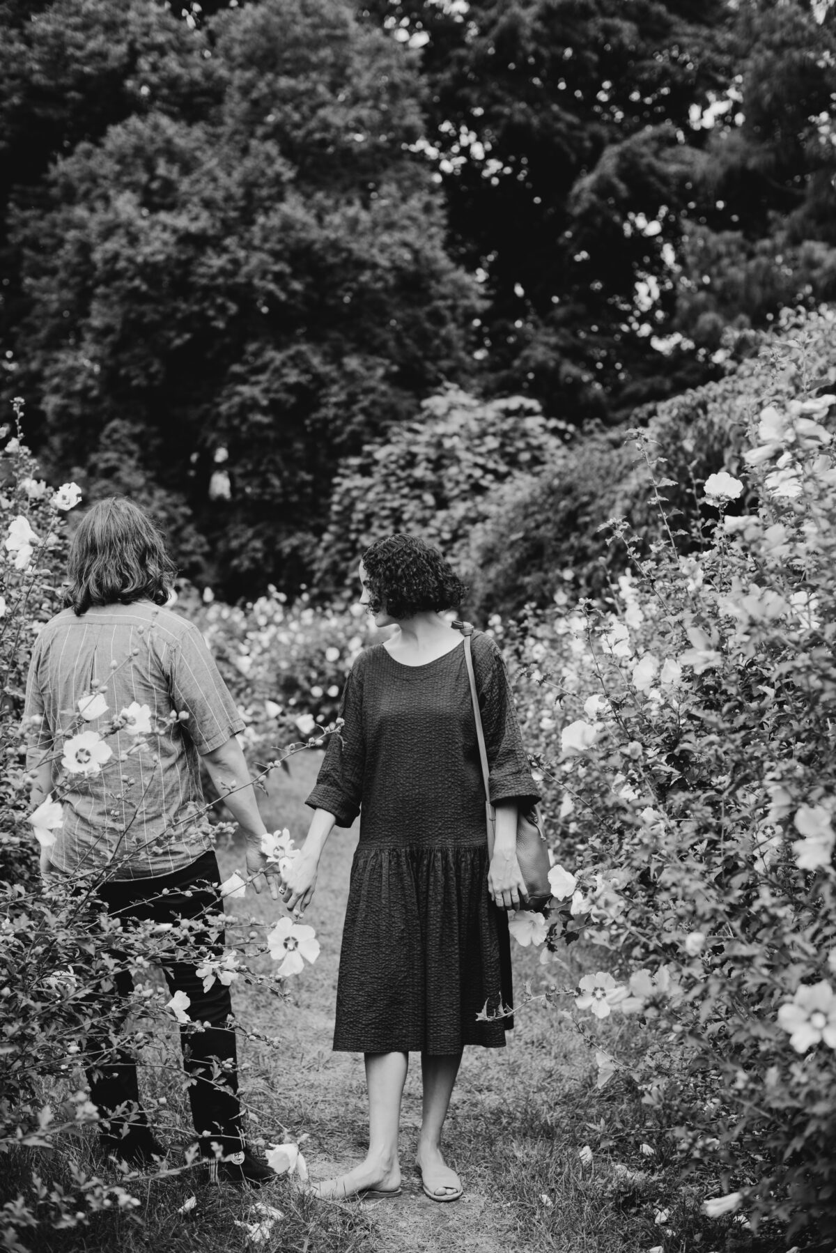Black and white portrait of a young couple standing in the rose garden at Prospect Park for their Brooklyn NT engagement portraits
