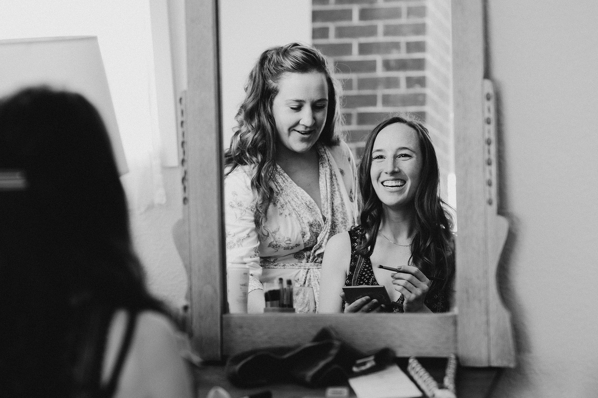 Bride Looking in Mirror on Wedding Day by Briana Morrison Photography
