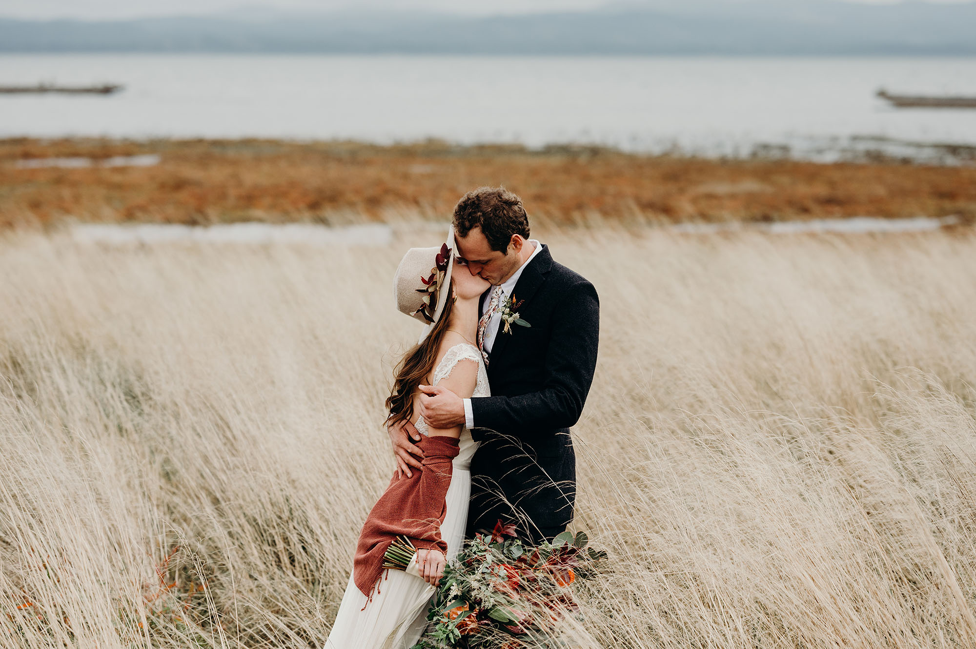 Bride & Groom Kissing in the Dunes by Briana Morrison Photography