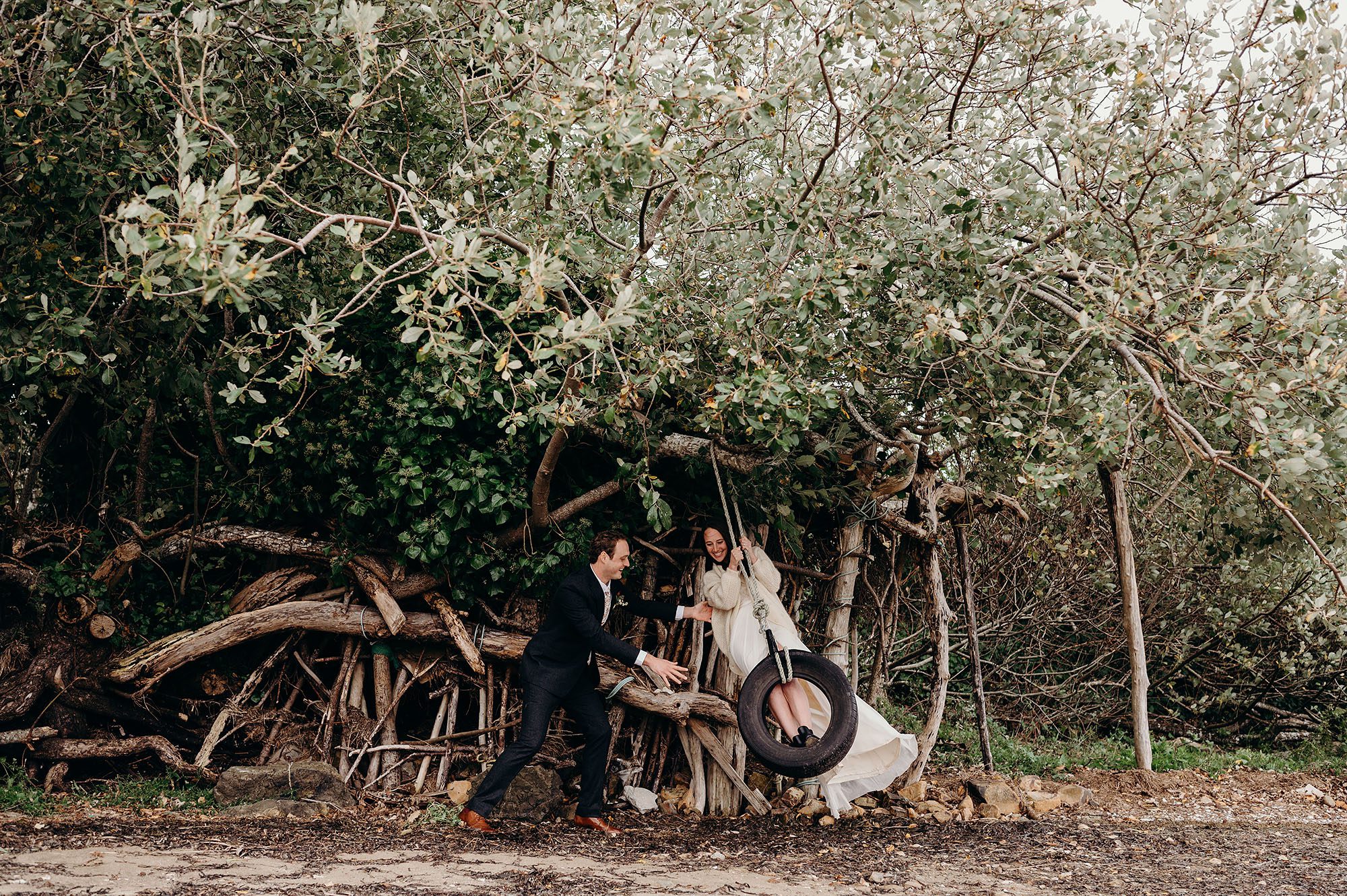 Bride & Groom Swinging on a Tire Swing by Briana Morrision Photography