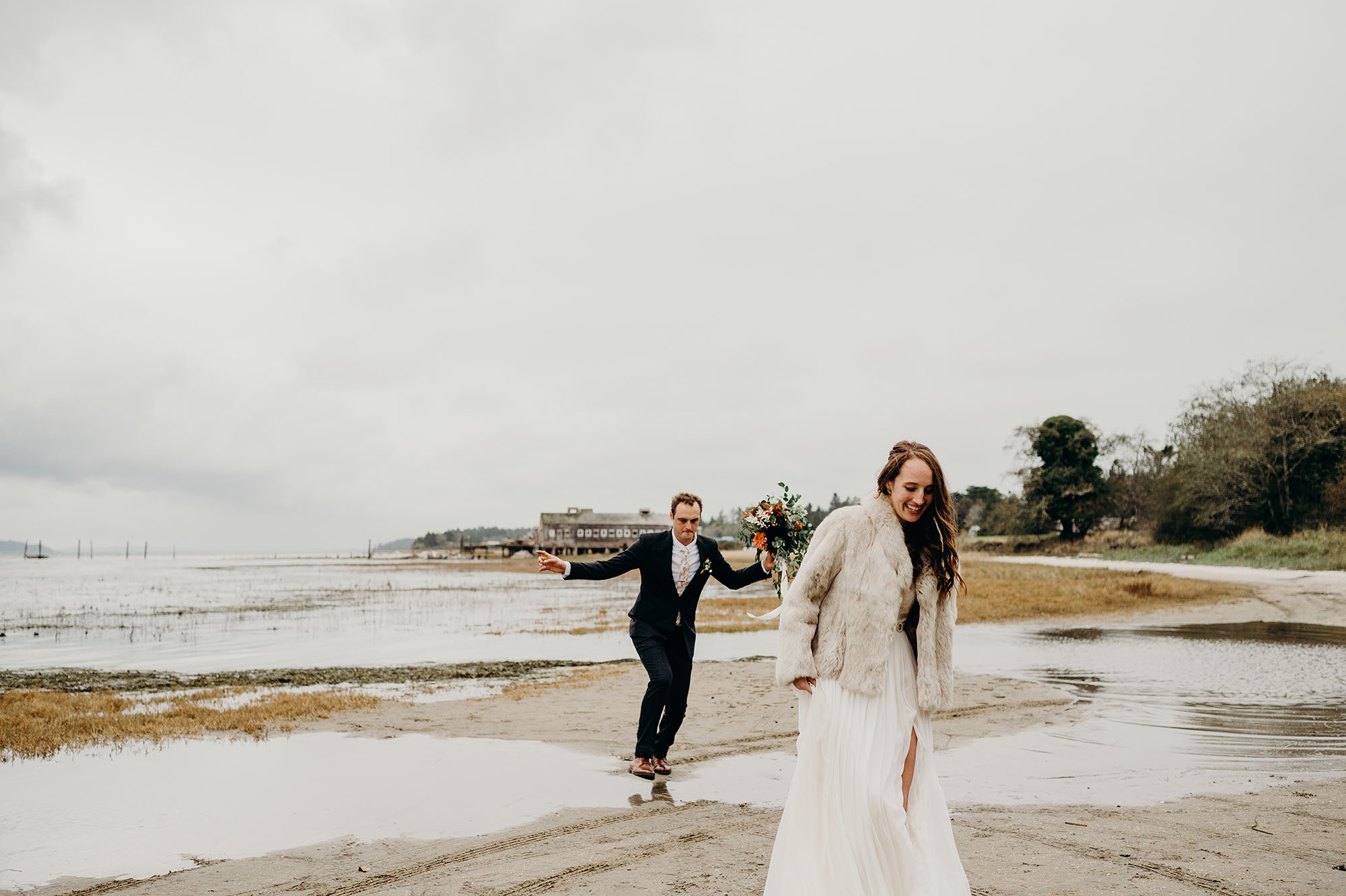 Bride & Groom Walking on the Beach by Briana Morrison Photography
