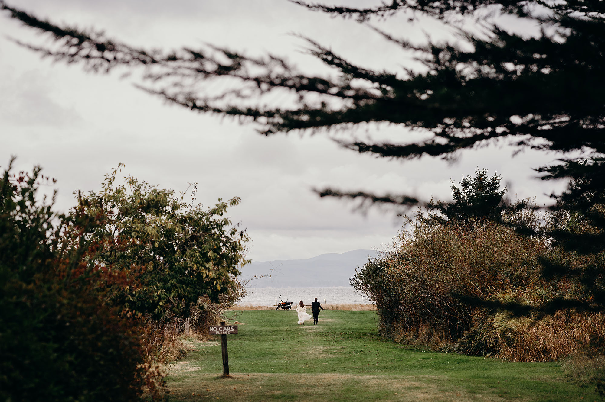 Long Beach Peninsula Wedding Bride & Groom Running towards the Sea by Briana Morrison Photography