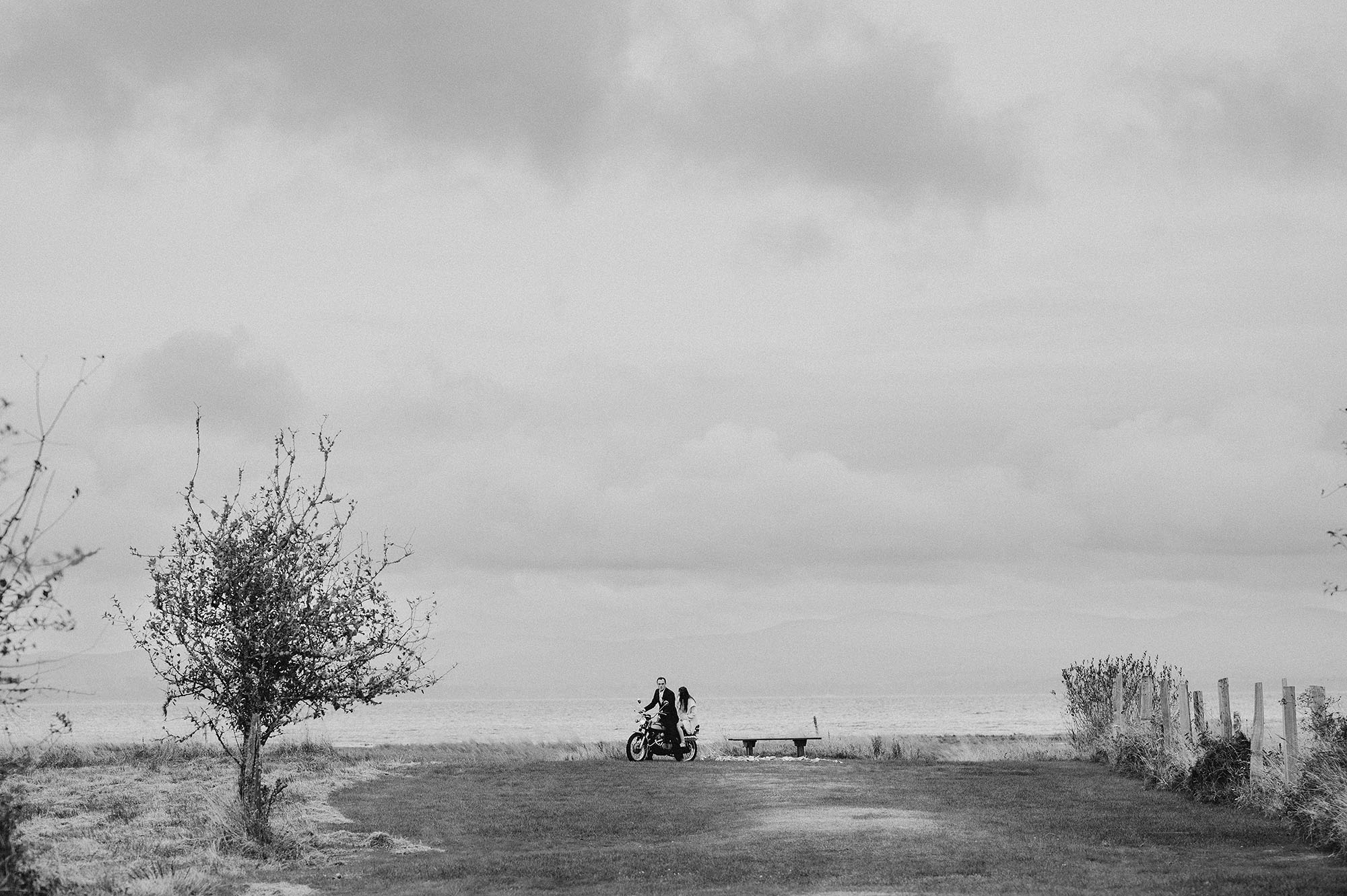 Long Beach Peninsula Wedding Bride & Groom Riding Back on Motorcycle in Black and White by Briana Morrison Photography