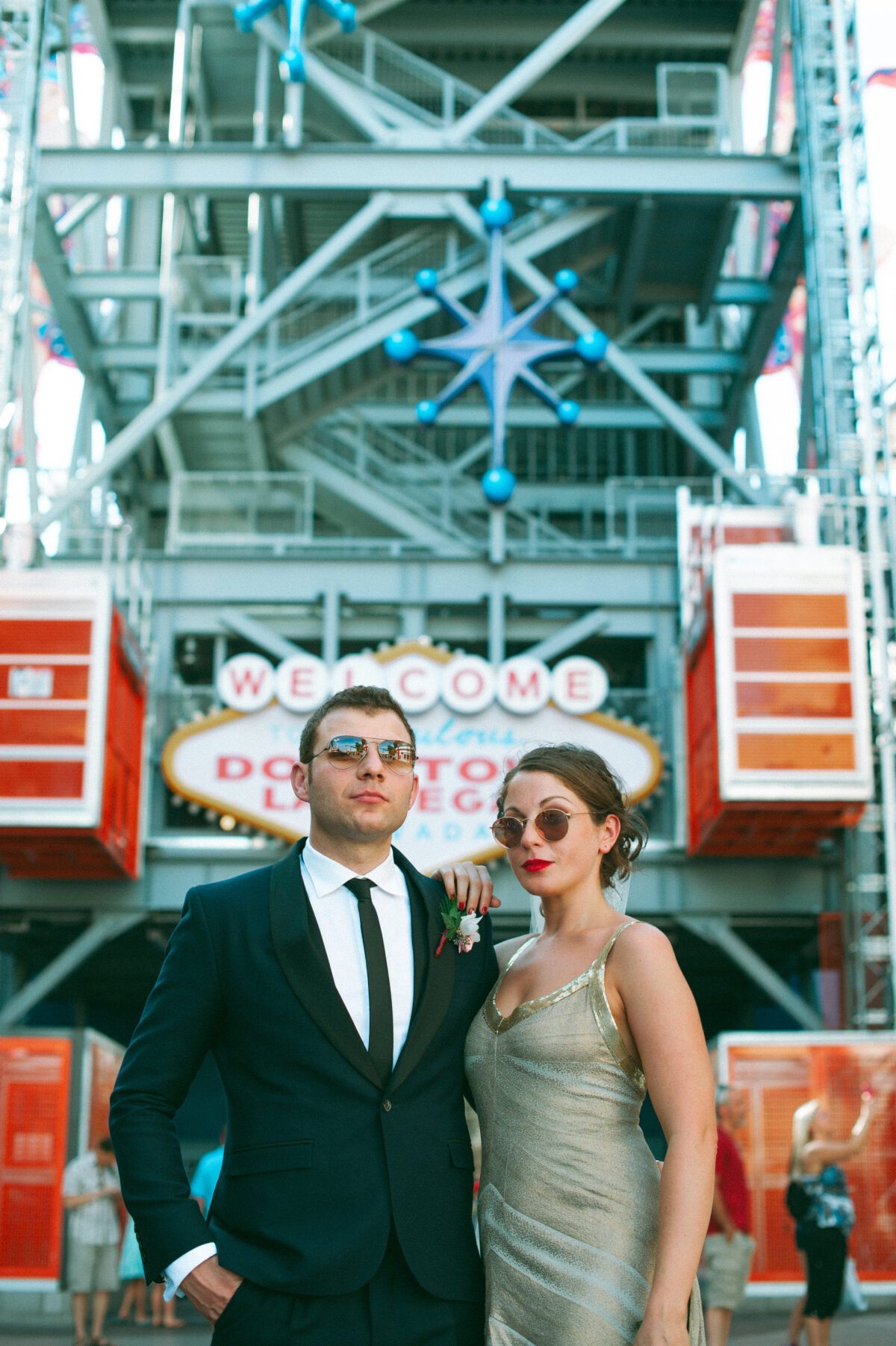 Sexy portrait of a newlywed couple posing in front of the Welcome to Las Vegas sign in Old Vegas