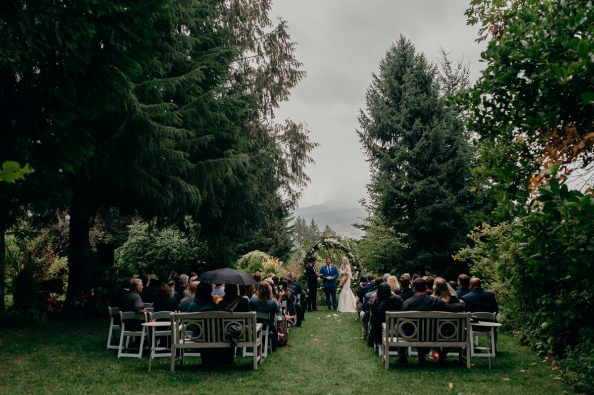 Mt Hood Organic Farms outdoor ceremony site filled with guests on a rainy day