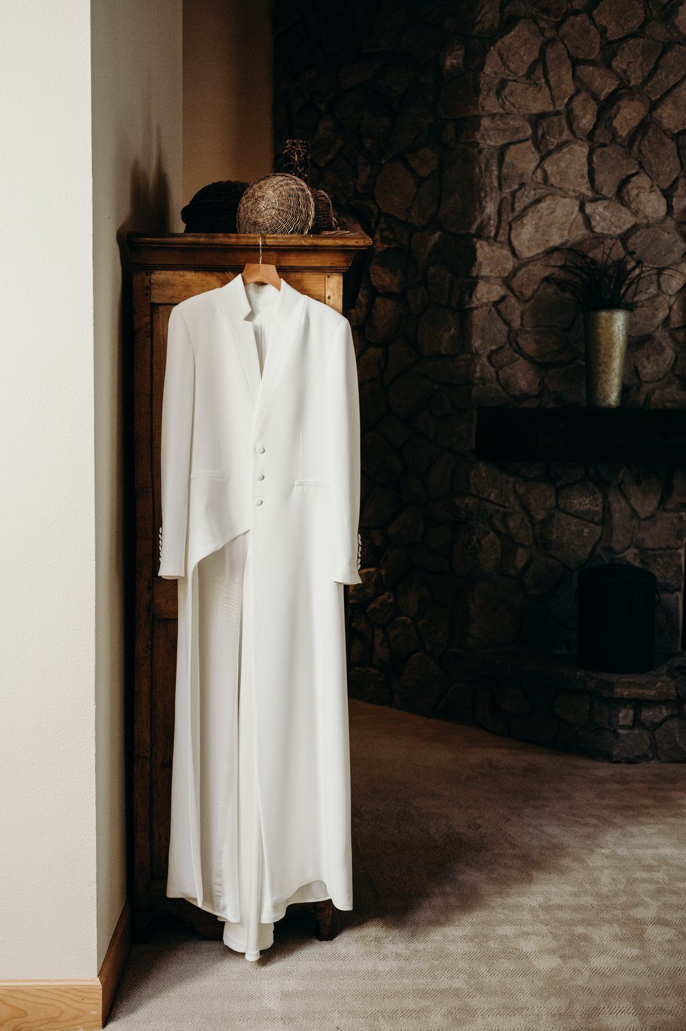 A couture white suit hangs in the getting ready suite at this rentable home on Black Butte Ranch.