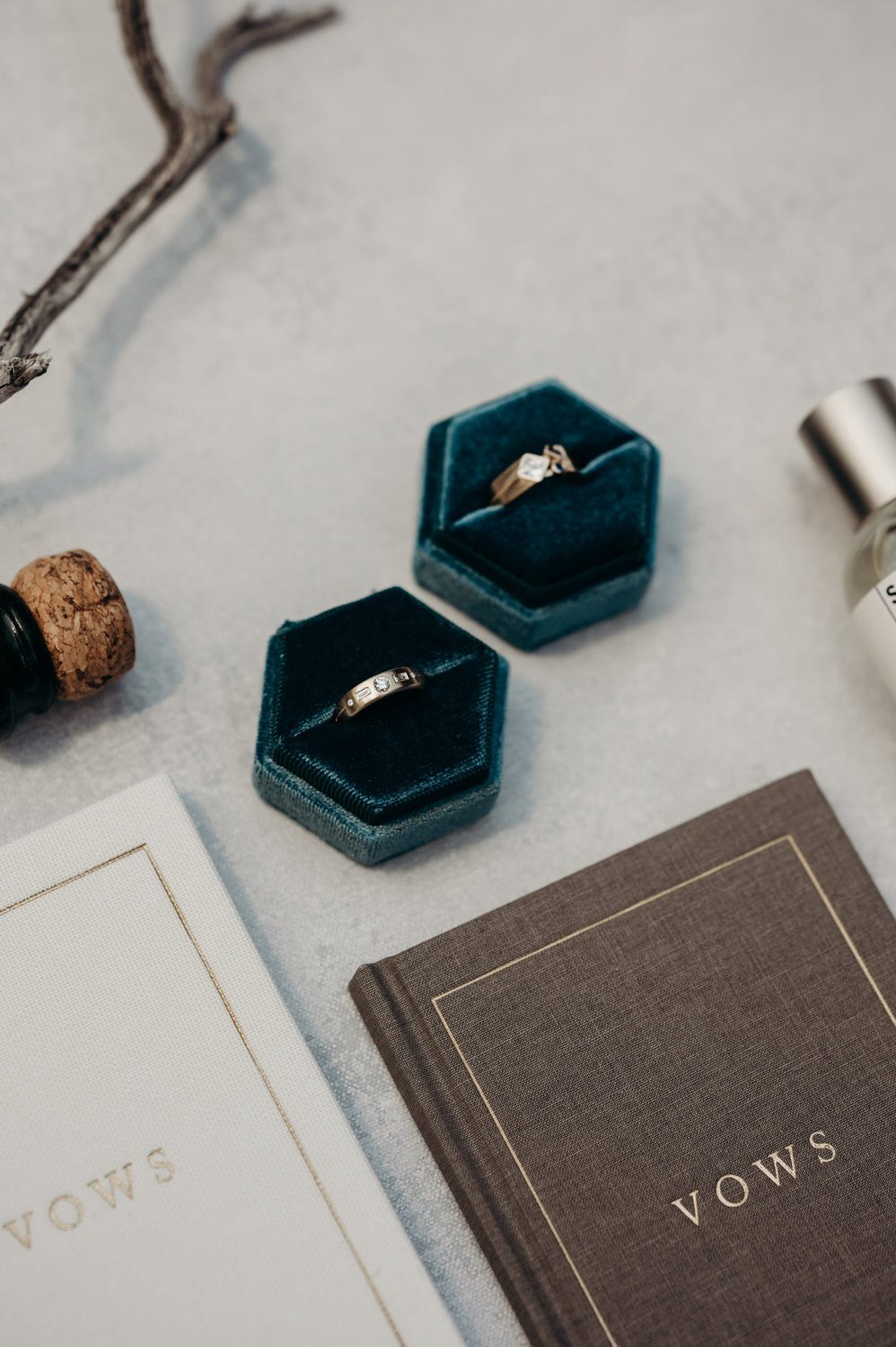 Wedding details including rings and vow books.