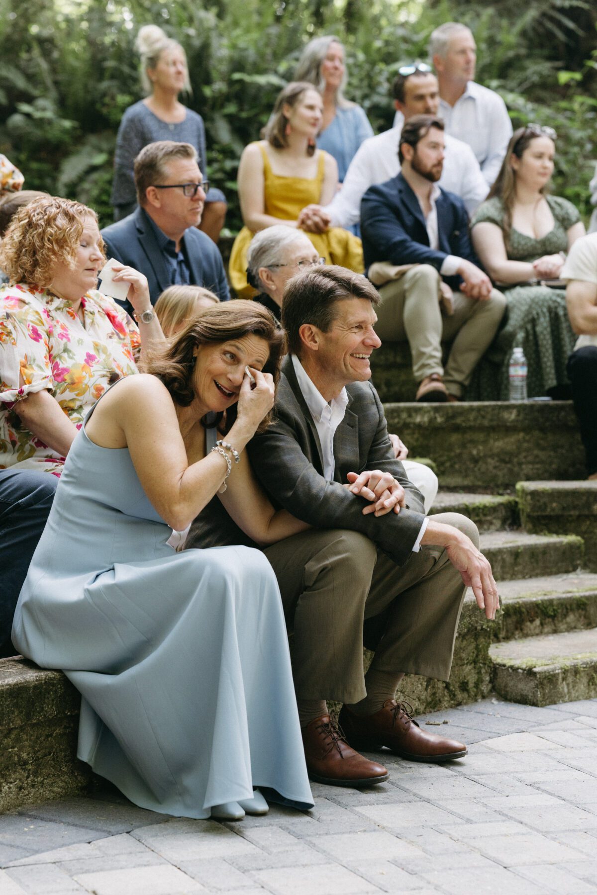 Parents of the bride cry with joy at their daughter's ceremony. Photography by Briana Morrison